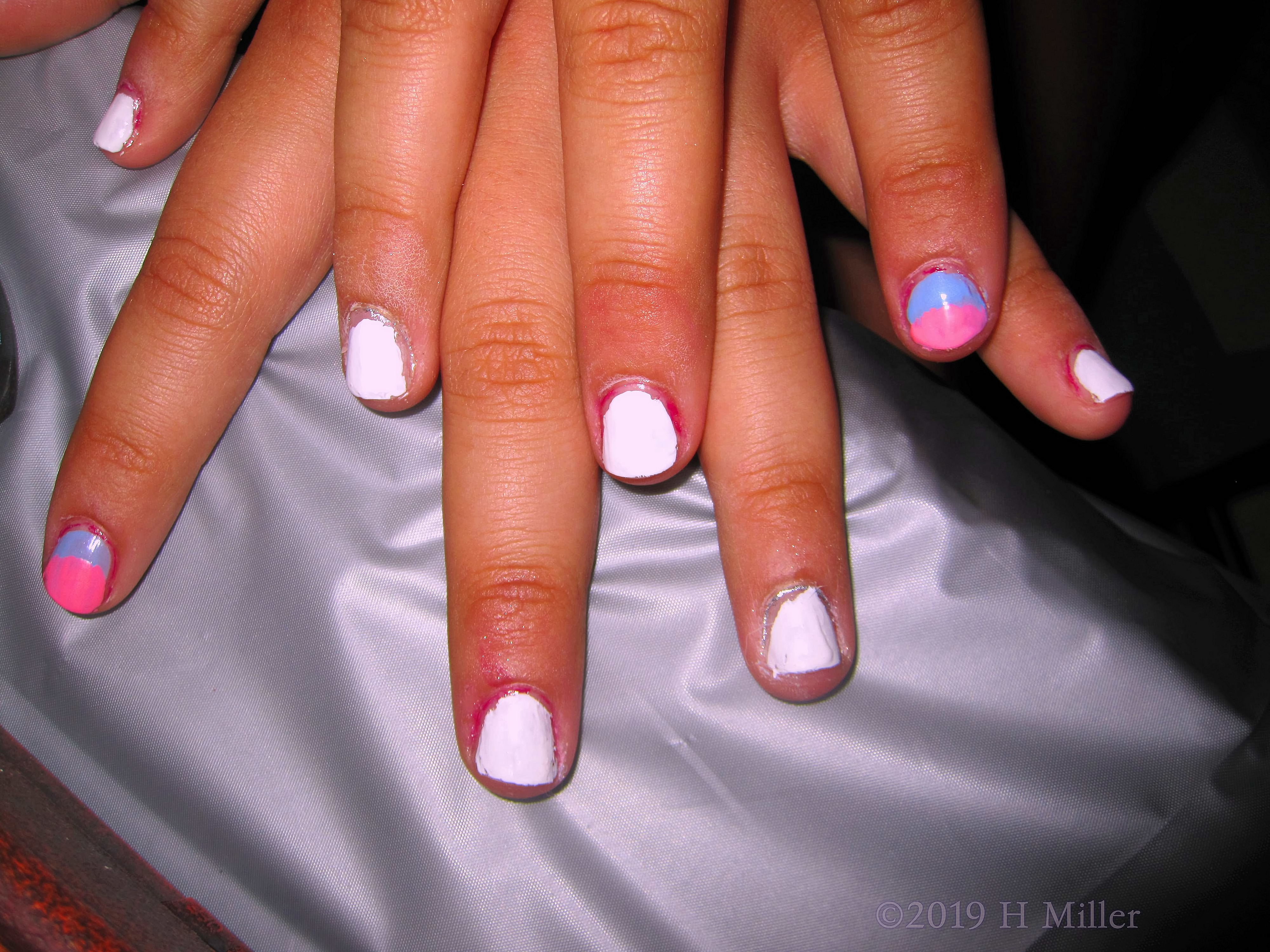 A Cute Kids Manicure With White, And A Pink And  Blue Ombre Nail Design.